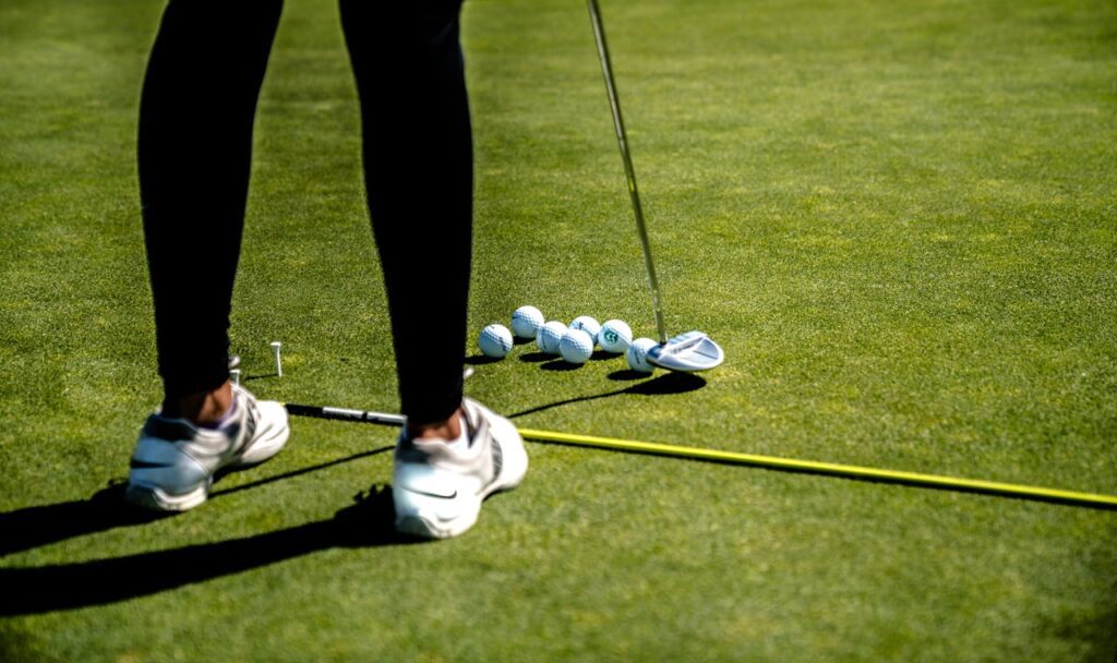 Lady golfer testing the feel of a golf ball.