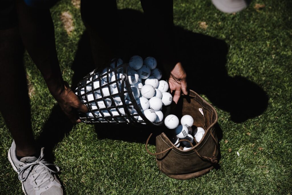 Golfer at the driving range measuring their swing speed to help find the right golf ball