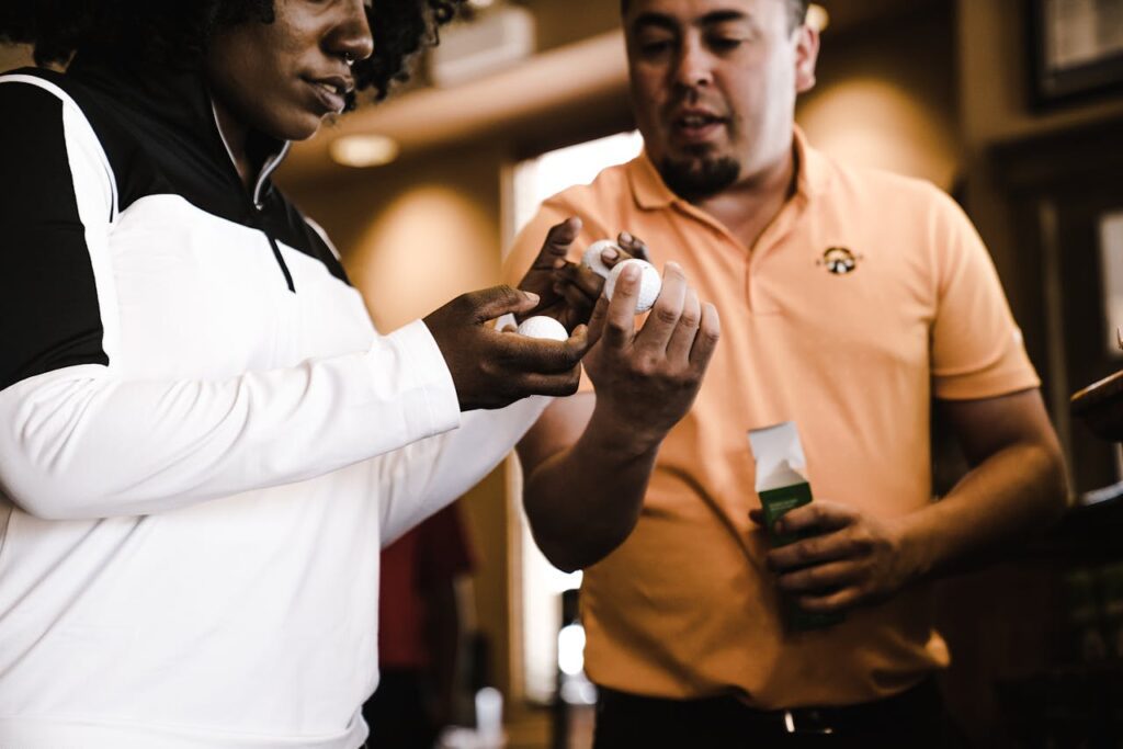 Pair of golfers looking at the different types of golf ball constructions